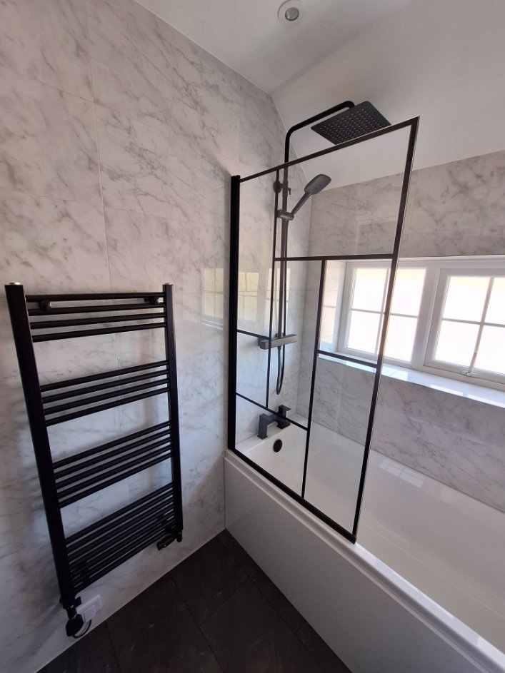 Marble & Black Shower by Bhatt Plumbing & Heating